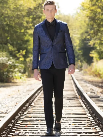 Man on railroad track in a cobalt blue paisley jacket