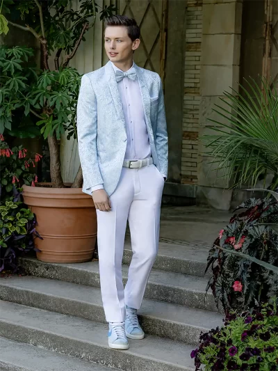 Man in a blue wedgewood paisley jacket and white pants