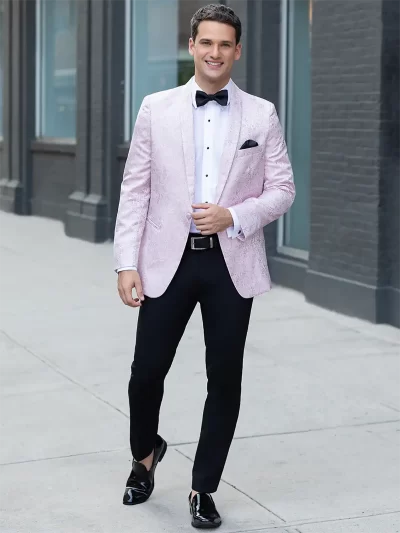Man in a pink quartz paisley jacket and black pants